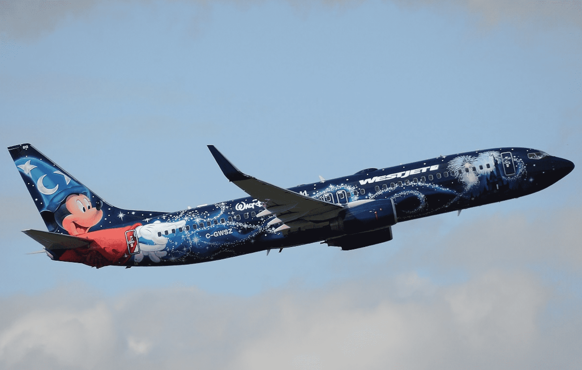 A Westjet 737 in a Disney-themed livery shortly after take-off.