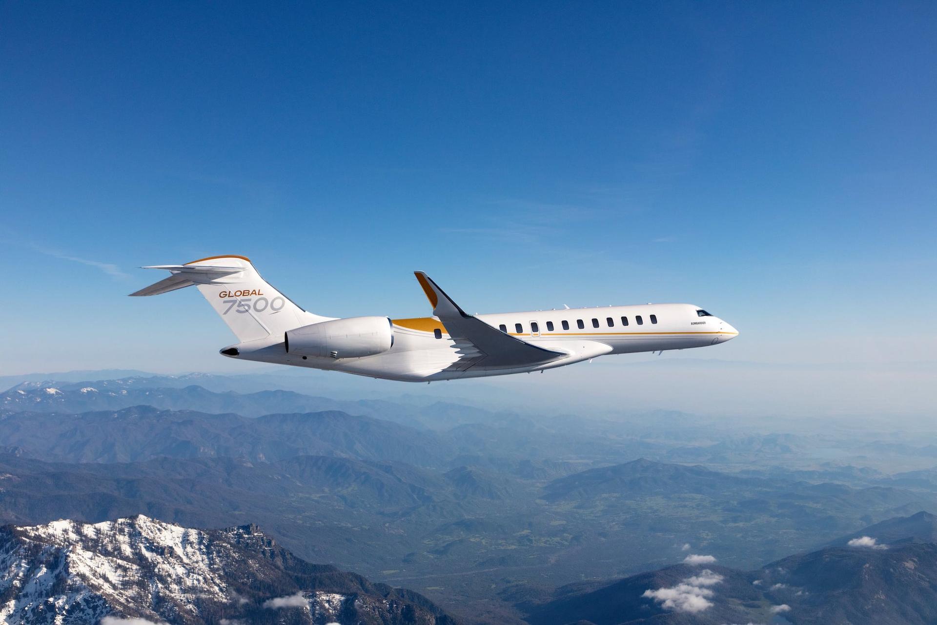 A Bombardier Global 7500 flying over snowy mountain tops.