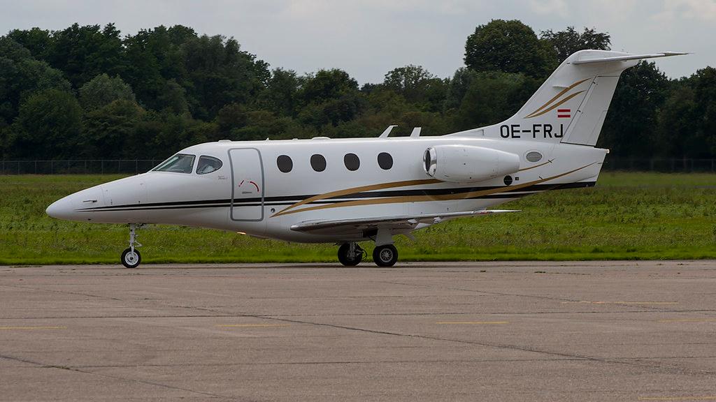 A white Hawker Beechcraft Premier 1 on the ground at Groningen Airport Eelde.