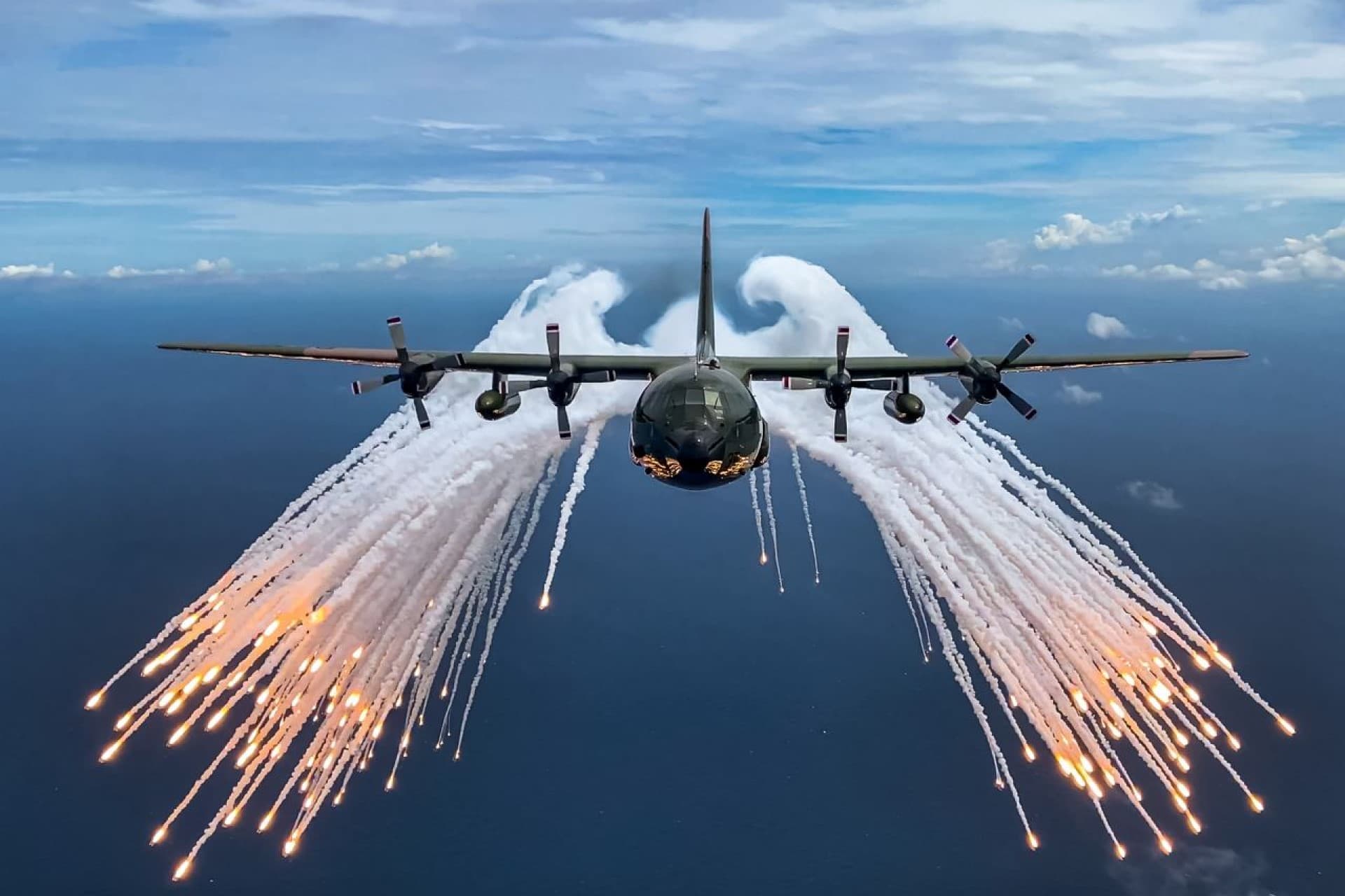 An AC-130 deploying flares in mid-air.