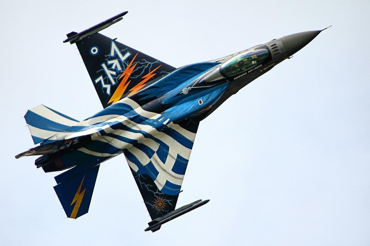 A Hellenic Air Force F-16 in a "Zeus" livery, which includes a Greek flag and orange lightning bolts.