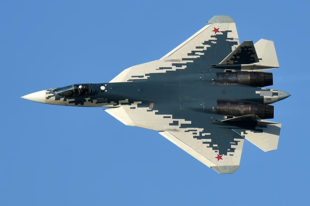 A Sukhoi SU-57 stealth fighter jet in a blue and gray digital camo livery.