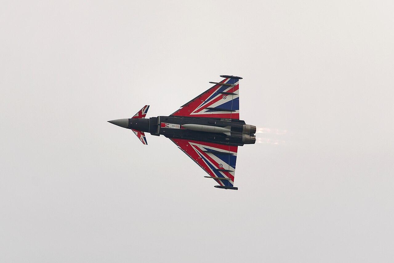 The UK Royal Air Force Typhoon “Union Jack” livery flying in a cloudy sky.