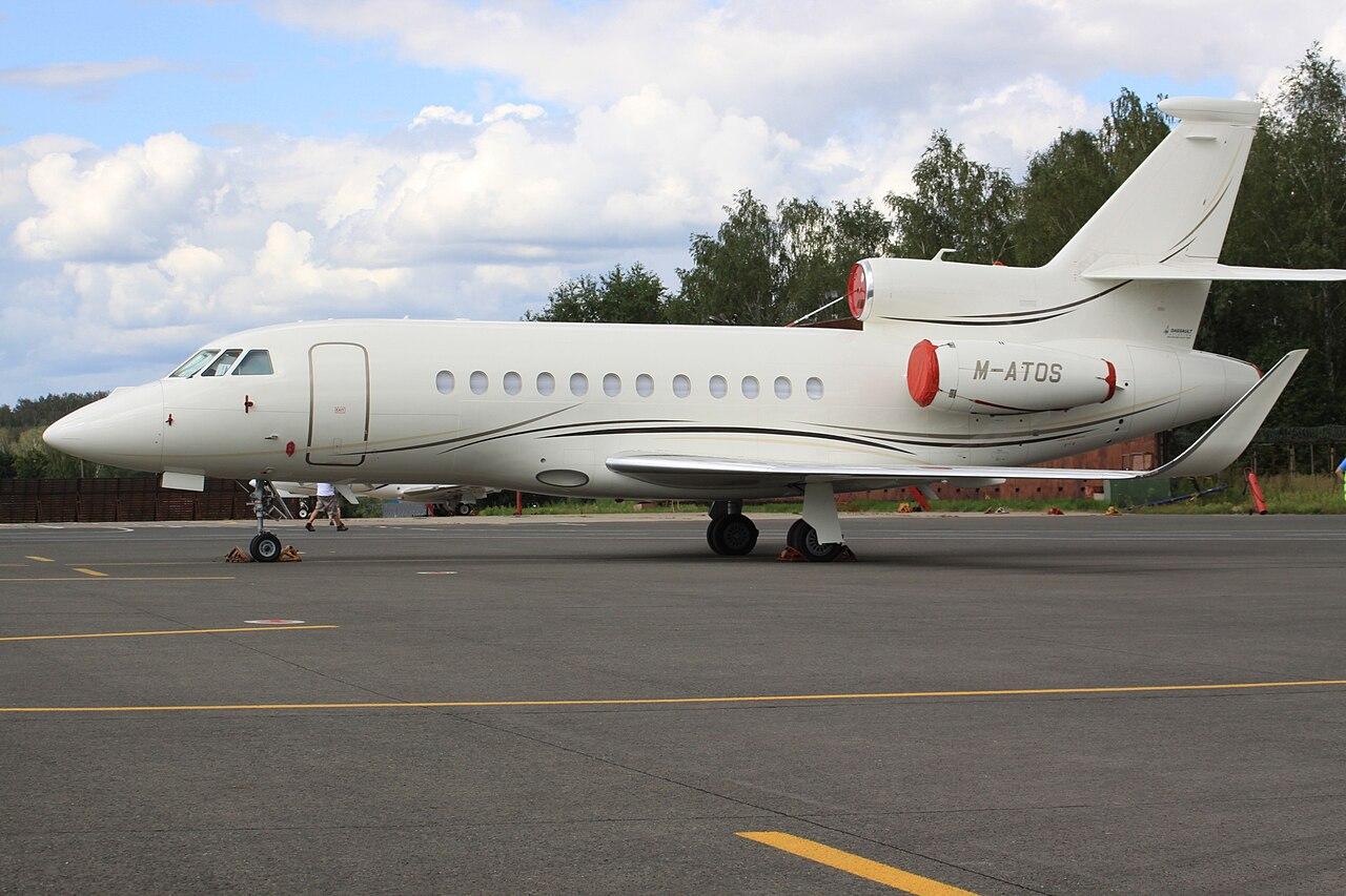 A Dassault Falcon 900LX parked outside at an airport.